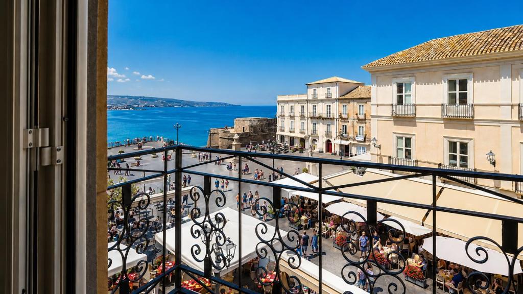 a balcony with a view of a city and the ocean at Il Marchesino B&B in Pizzo