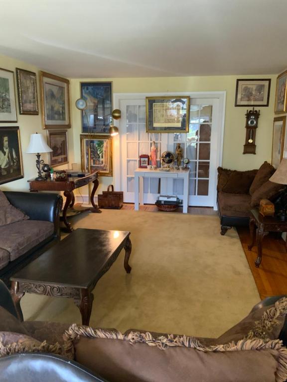 a living room with couches and a table at Half a Mansion in Pomfret