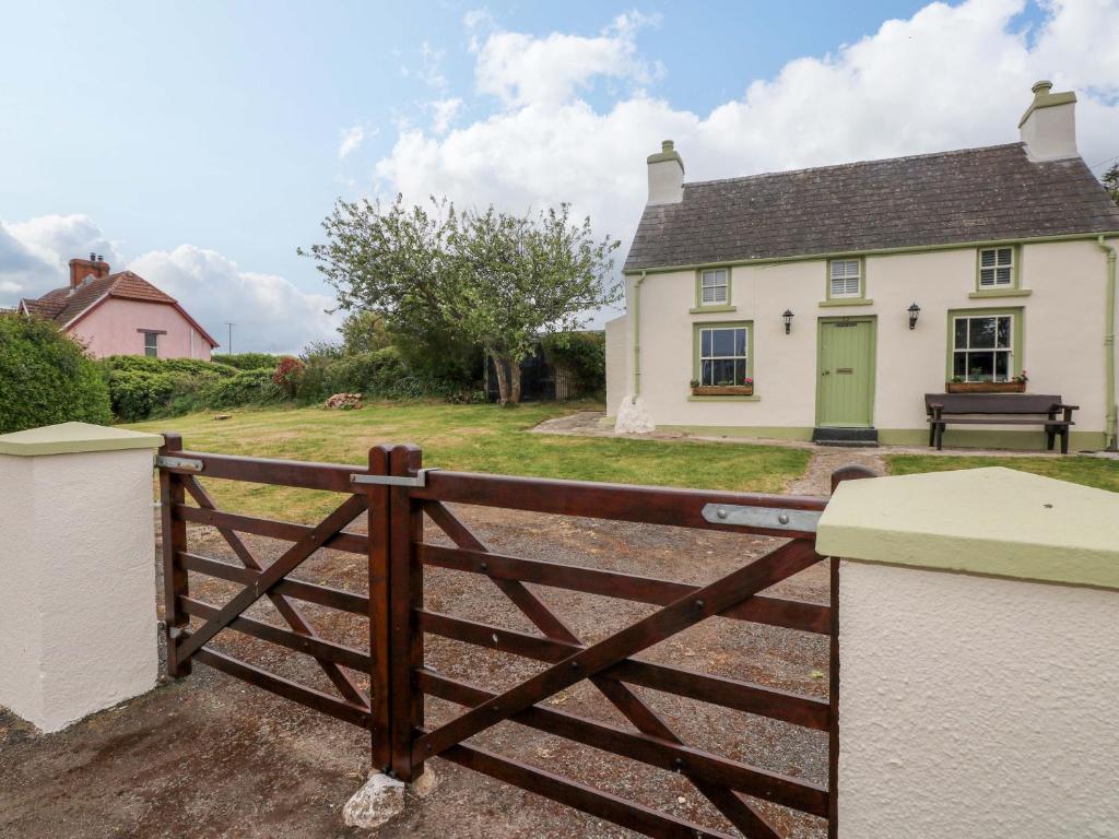 a house with a wooden fence in front of it at Beacon House in Haverfordwest