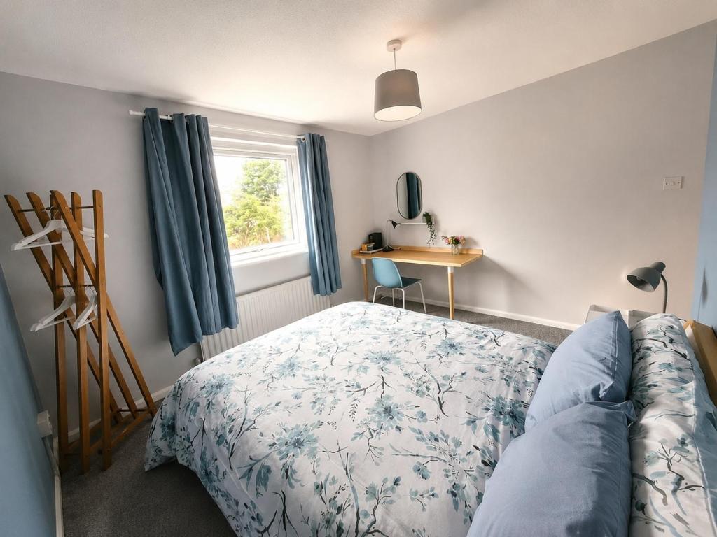 a bedroom with a bed and a desk and a window at Double Room Near Cardiff Bay Waterfront in Cardiff