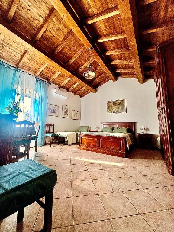 a living room with a bed and a table at Il FONTANONE in Veiano