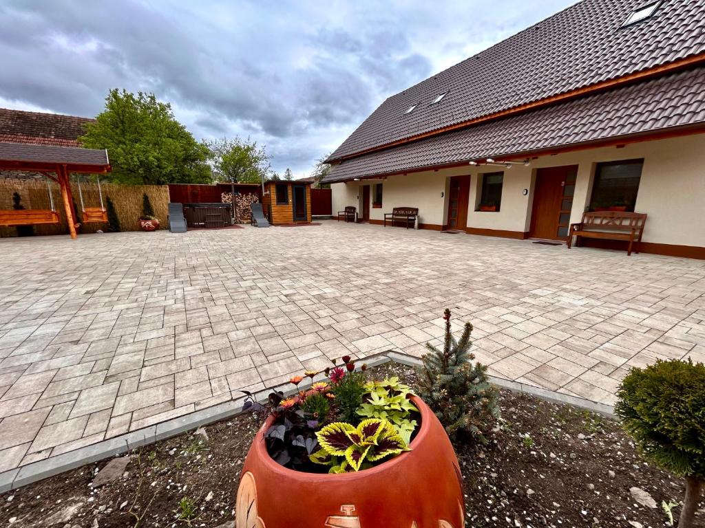 a large flower pot sitting in the yard of a house at BT Apartman in Miercurea-Ciuc