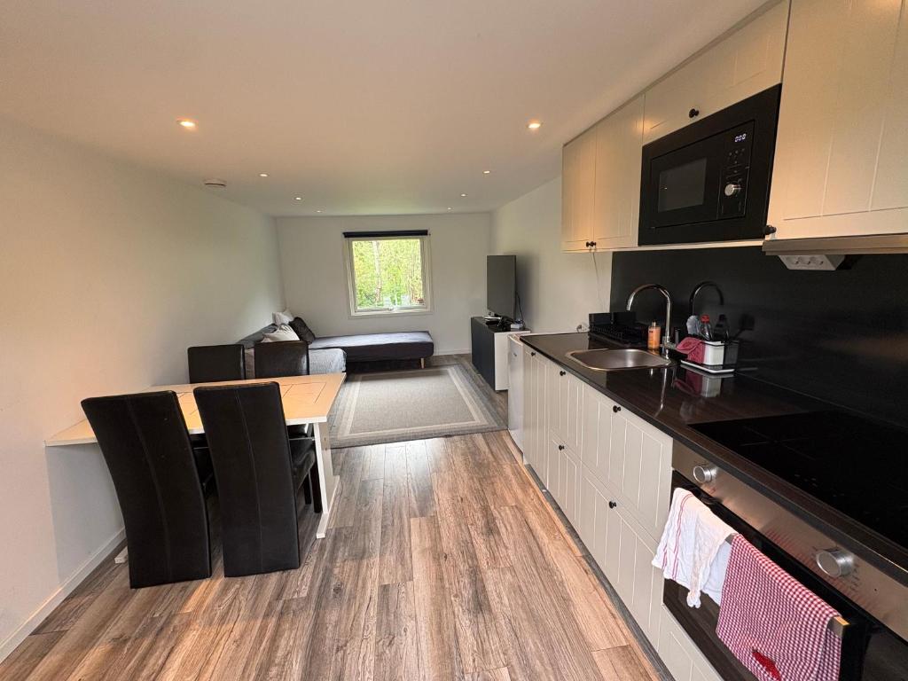 a kitchen with a table and a counter top at Modern villa apartment with free parking in Sollentuna