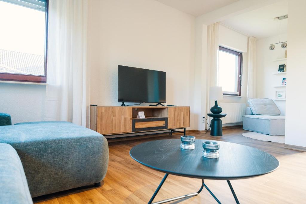 a living room with a tv and a coffee table at Landhaus Mira in Witzenhausen