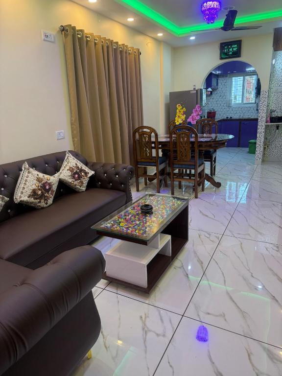 a living room with a couch and a table at Orchid 3BHK 3AC in New Town