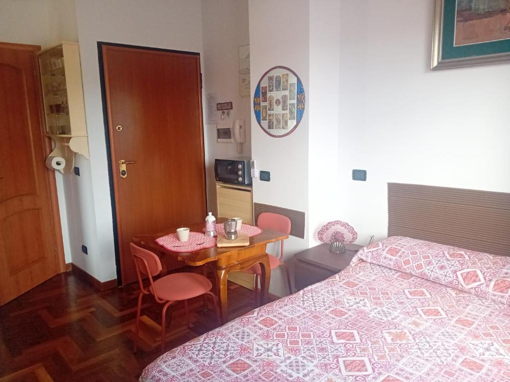 a bedroom with a bed and a table and a bed and a table and chairs at Studio Liberty in Fiuggi