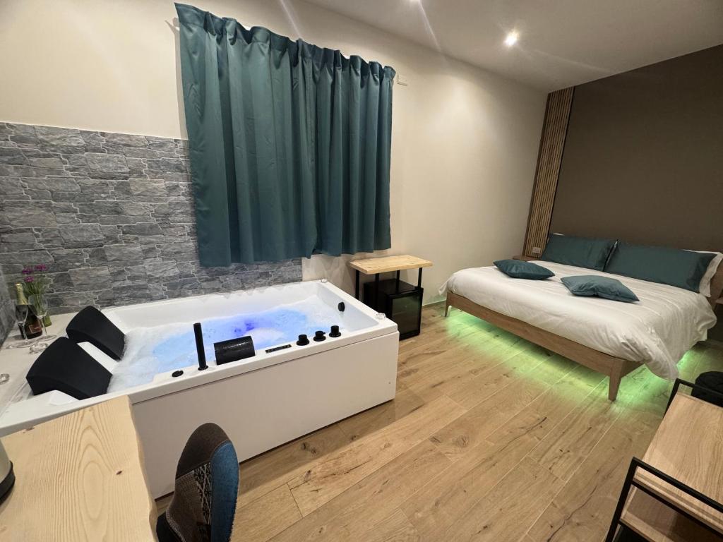 a room with a bathtub in the middle of a bedroom at La Mora Rooms in Linguaglossa
