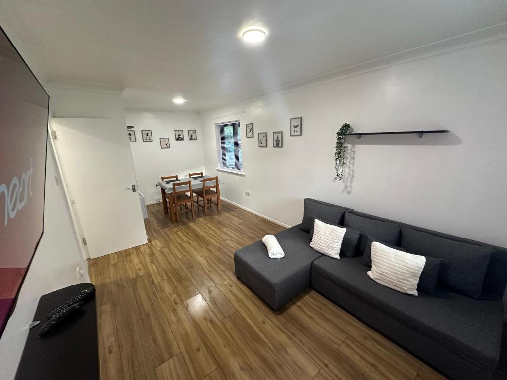 a living room with a couch and a table at Spacious 1bed Apartment Close To Town in Ifield