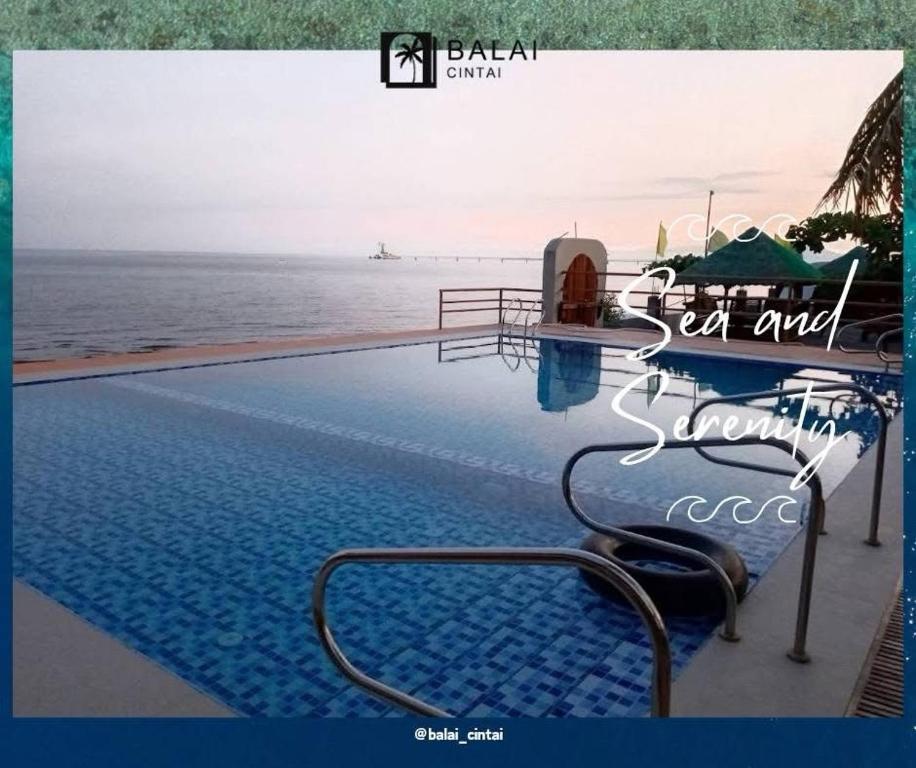a picture of a swimming pool next to the ocean at Balai-Cintai Beach Resort in Castañas