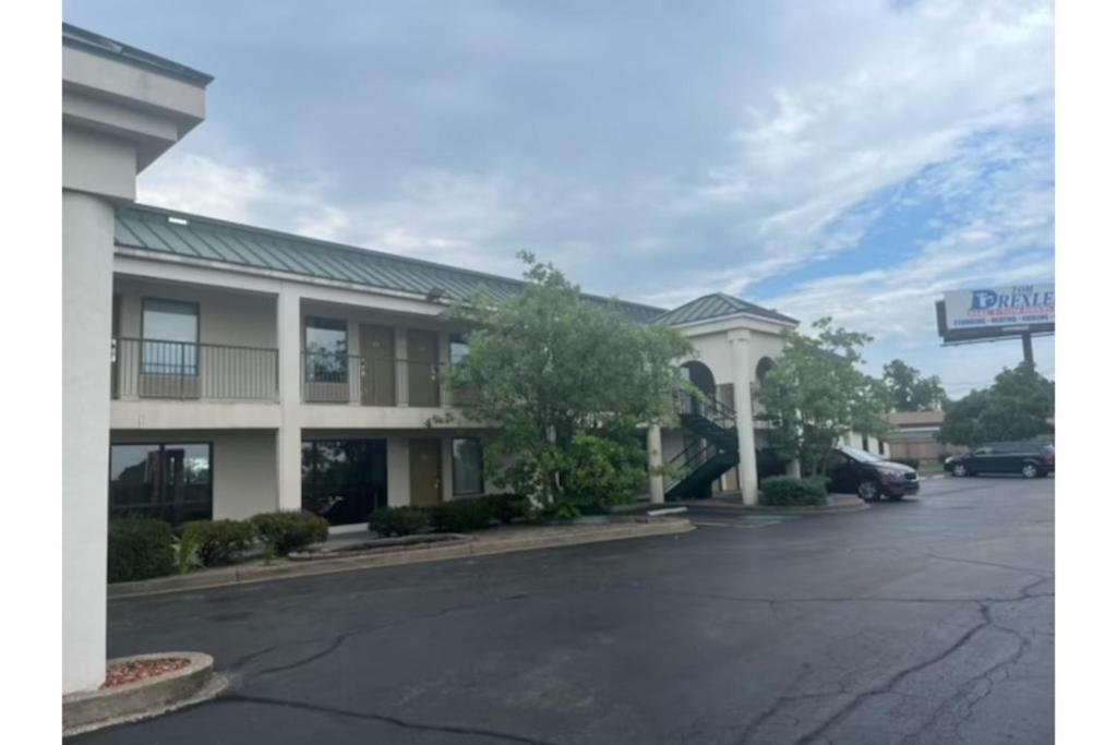 a hotel with a parking lot in front of it at Studio 6 Suites Louisville KY Airport/Expo Center in Louisville