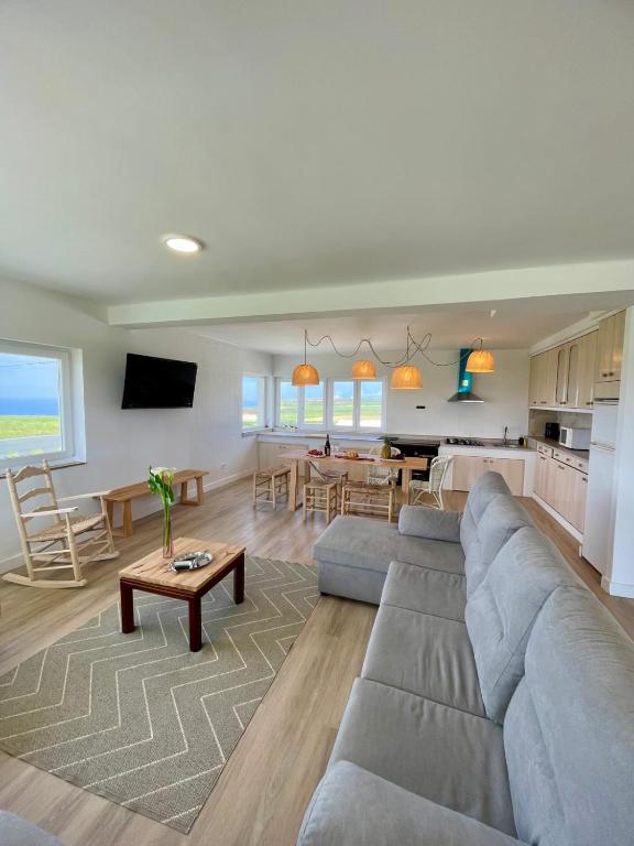 a living room with a couch and a dining room at Sol Dorado in Ferrero