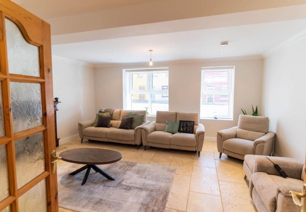 a living room with two couches and a table at The Townhouse in Cahersiveen