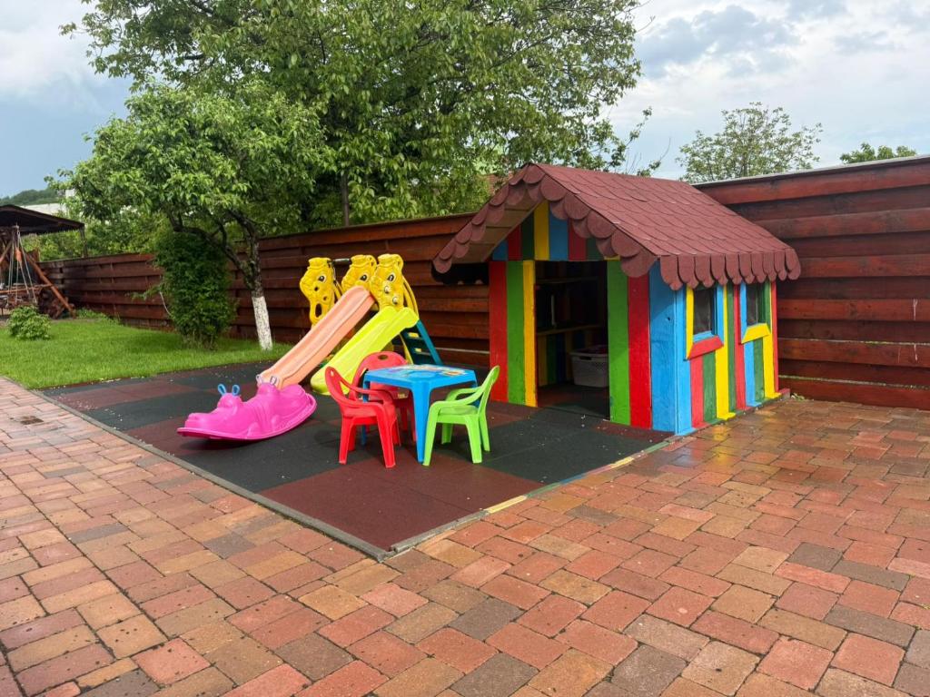 a playground with a slide and a play house at Casa SOL in Turda