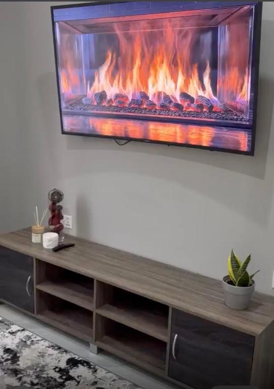 a living room with a fireplace on the wall at Black-Oak Apartments in Lusaka