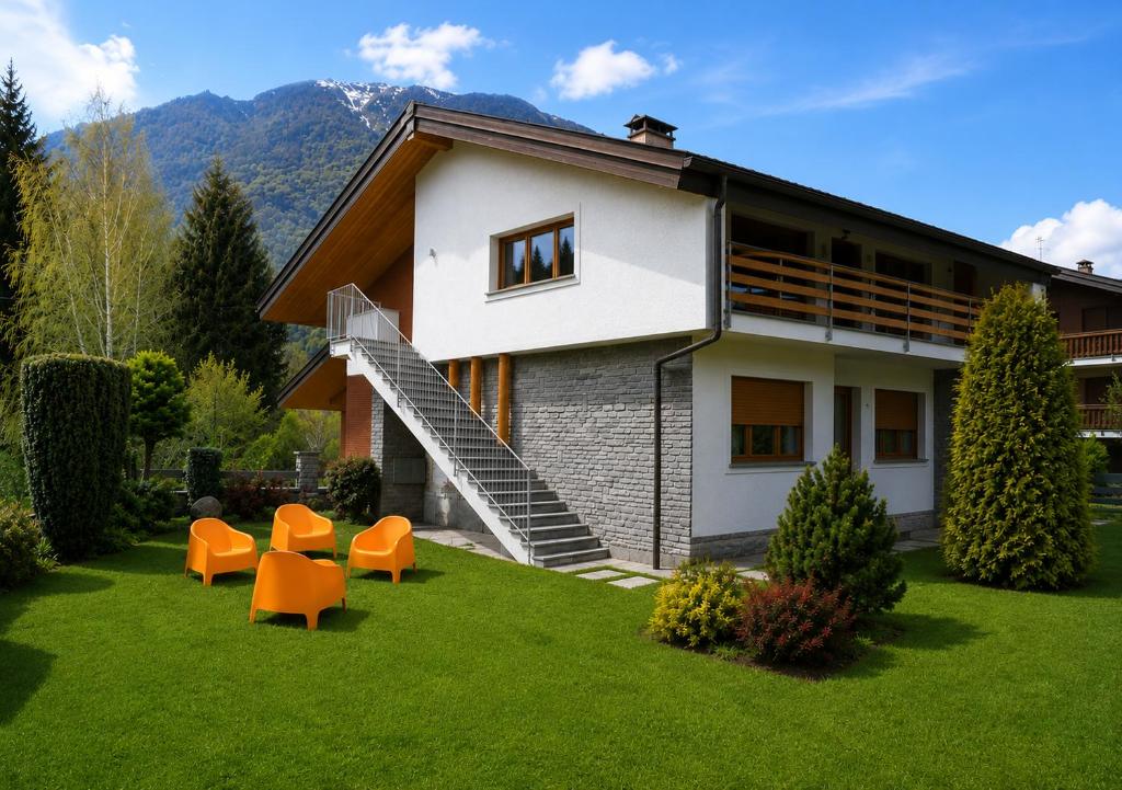 a house with orange chairs in the yard at Villa Rostagno in Entracque