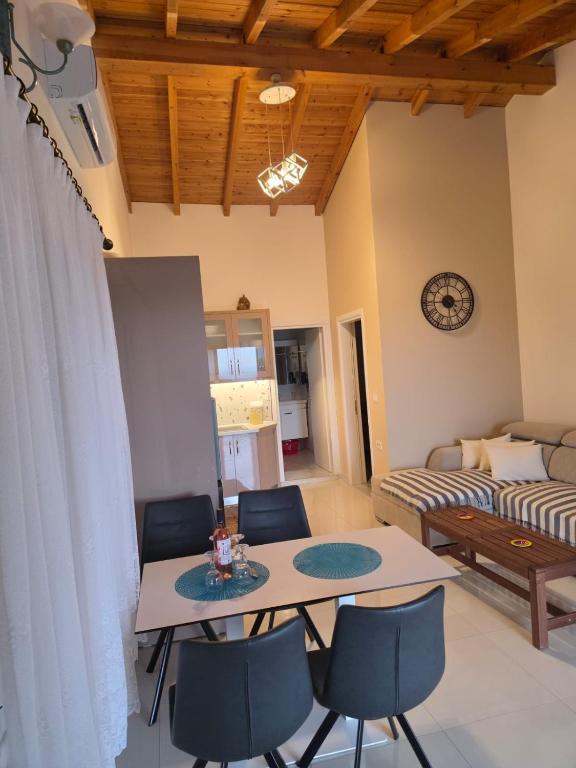 a living room with a table and chairs at apartment Himara SkyView in Himare