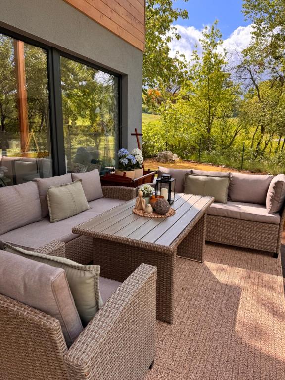 a patio with wicker furniture and a table at Chatka in Roztiezi in Roztěž
