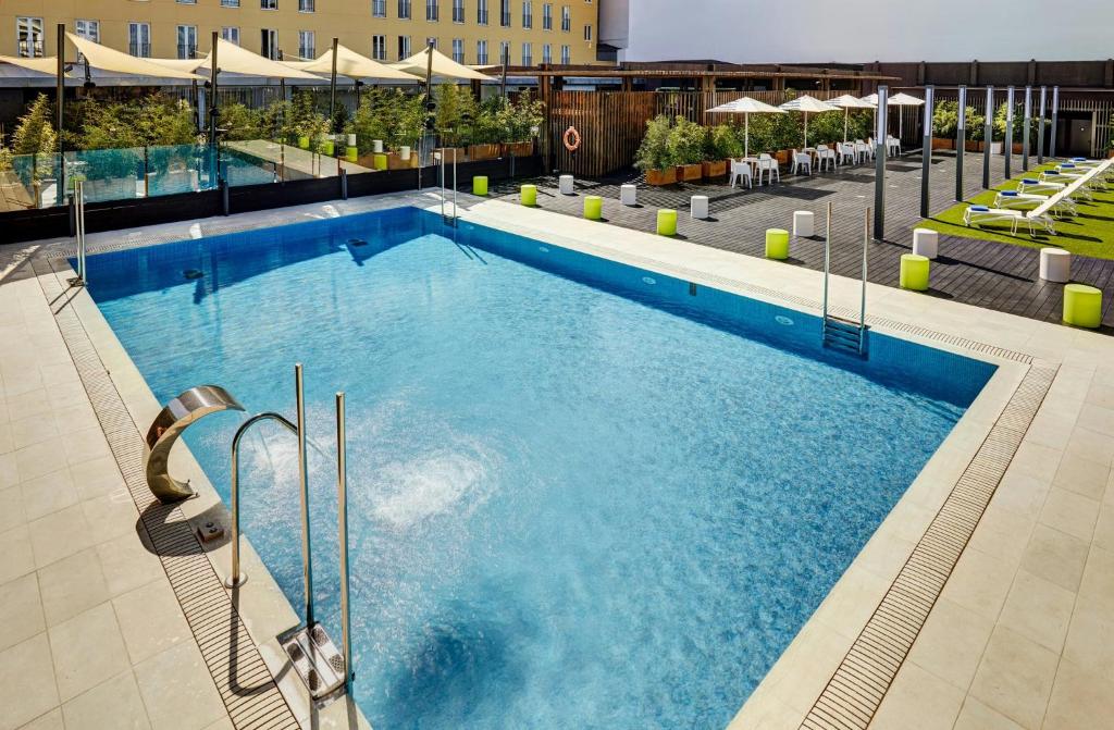 a large swimming pool on top of a building at Sercotel Alcalá 611 in Madrid