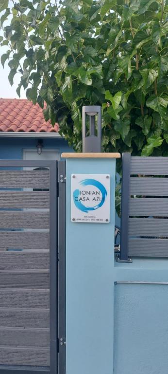 a utility box with a sign on the side of a fence at Ionian Casa Azul in Karavomylos