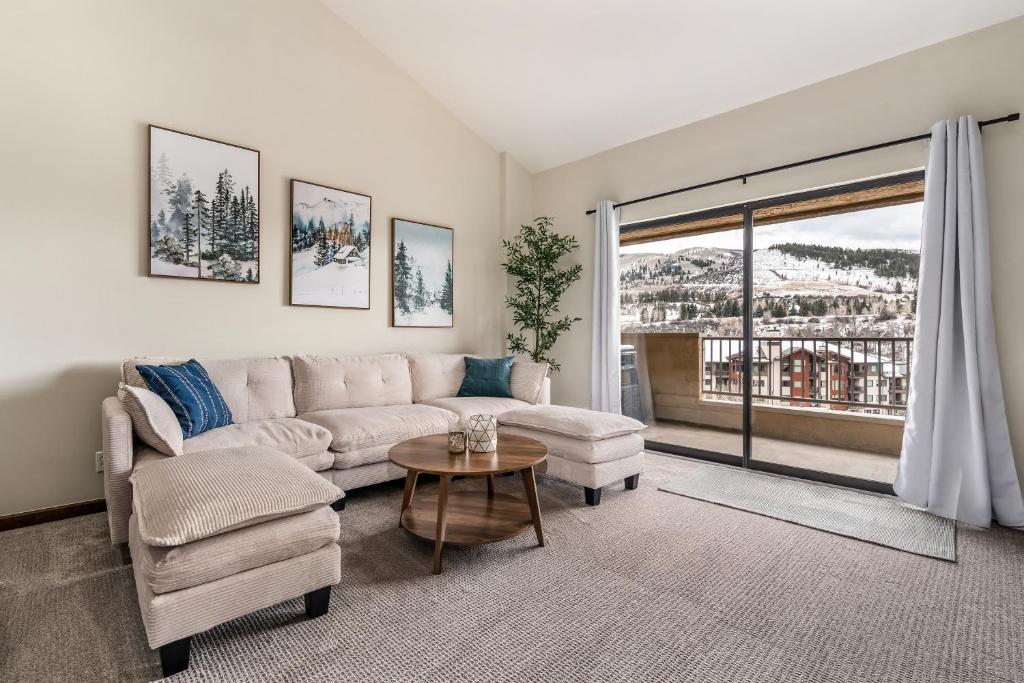 a living room with a couch and a table at Seasons Alpine Retreat in Avon