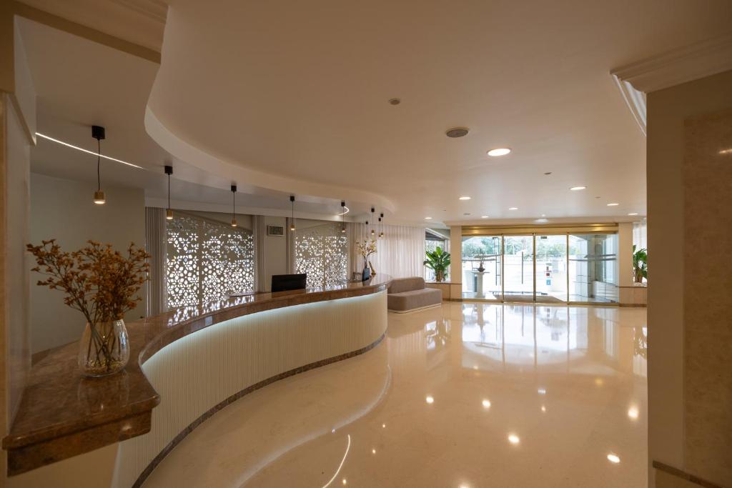 a large lobby with a white floor and a long hallway at Avenida de Fatima in Fátima