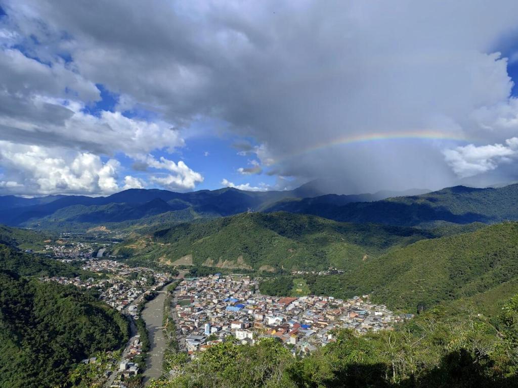 a rainbow over a city in the mountains at Estancia Mirador Reyes- Casa de la Montaña in Zamora