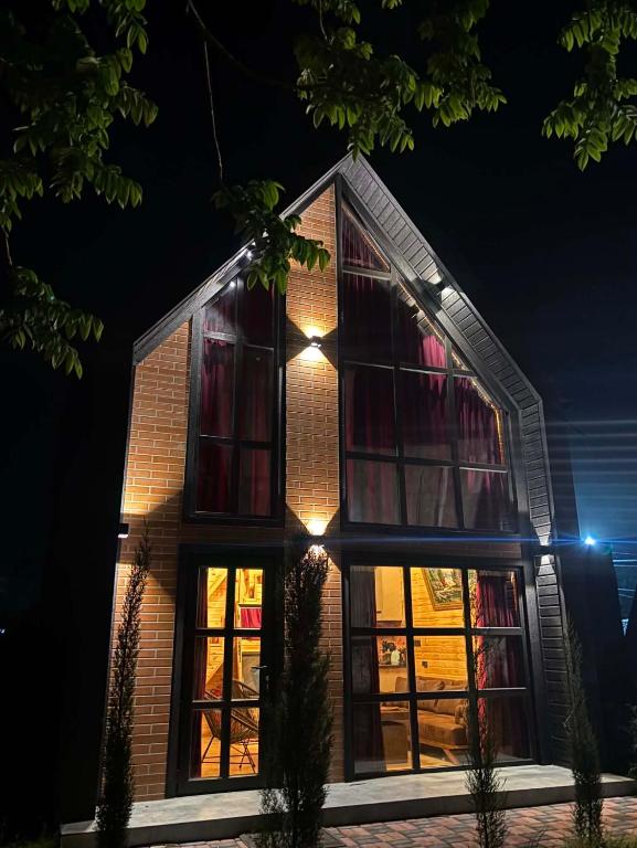 a house is lit up at night at Bondo'S Cottage in Kobuleti