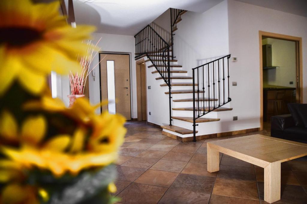 a living room with a staircase and a table at Roncati Family Apartment in Bellagio