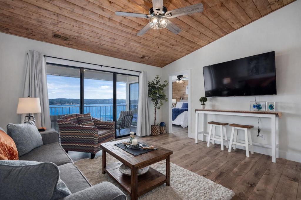 a living room with a couch and a table at Lakeview Getaway in Kimberling City