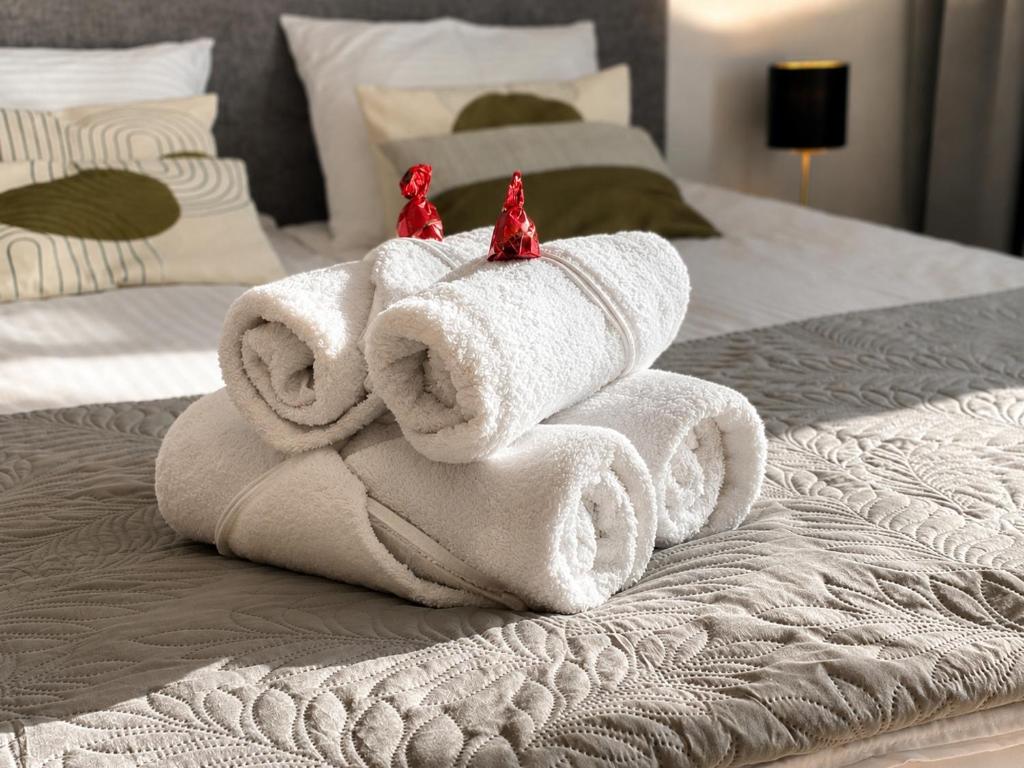 a towel animal made out of towels on a bed at Apart Studio Śródmieście in Gdańsk