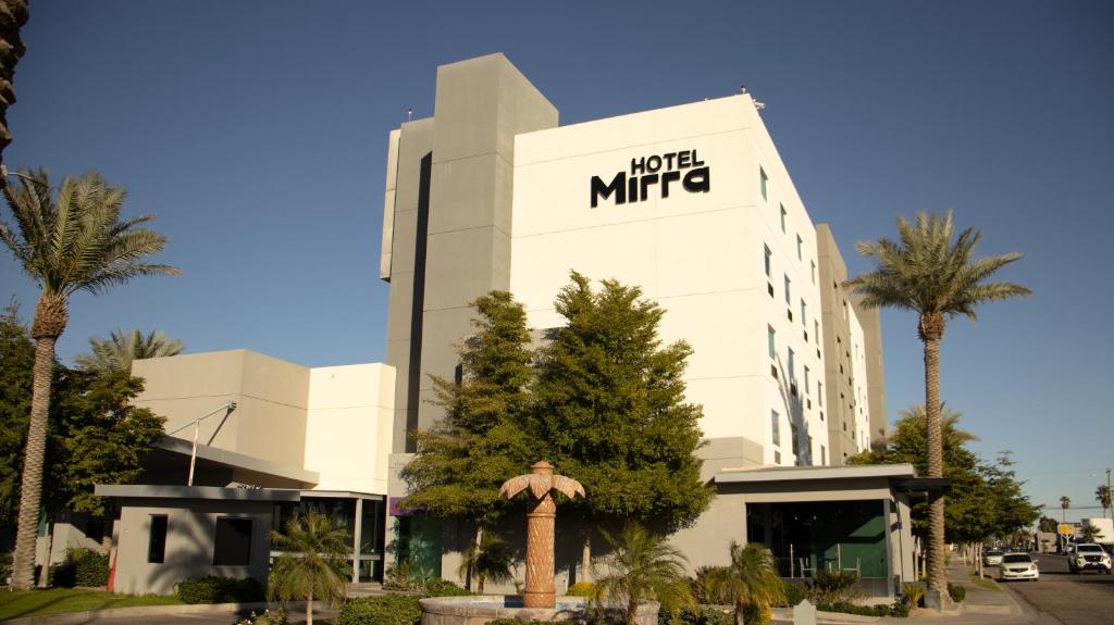 a large white building with a m hotel micropolitan at Hotel Mirra San Luis in San Luis Río Colorado