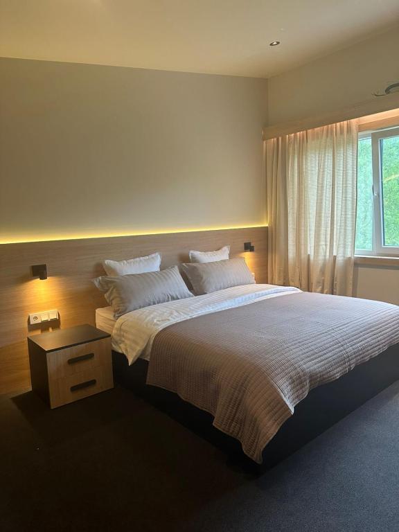 a bedroom with a large bed and a window at Креси in Yaremche