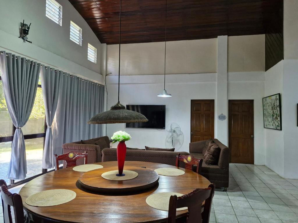 a living room with a wooden table and a couch at Casa Maria in Sibulan