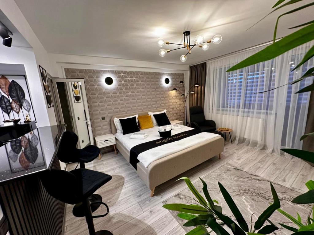 a bedroom with a bed and a couch and a table at Angely Studio-balcon & parcare gratuită ,Self Check-in in Onești