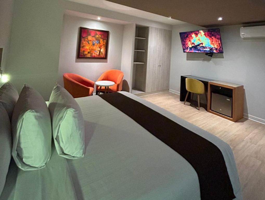 a hotel room with a bed and a tv at Hotel Inclan in Lima