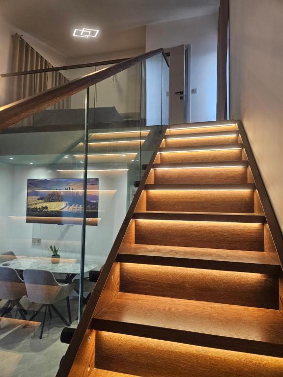 a staircase with glass railing in a house at Sage Villas in Plataria