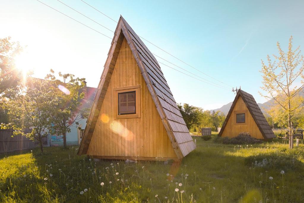 two small houses in a field of grass at Glamping by the Old Mill in Preddvor