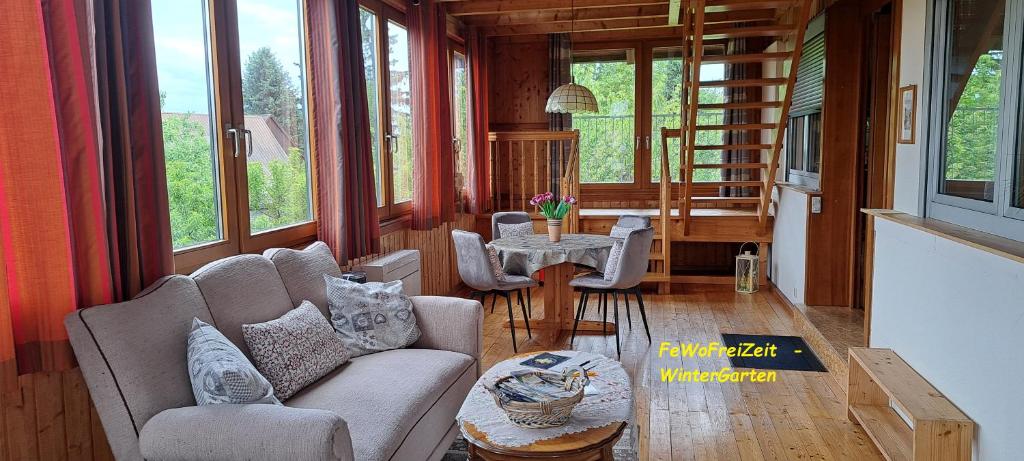 a living room with a couch and chairs and a table at FeWoFreiZeit in Rheinau