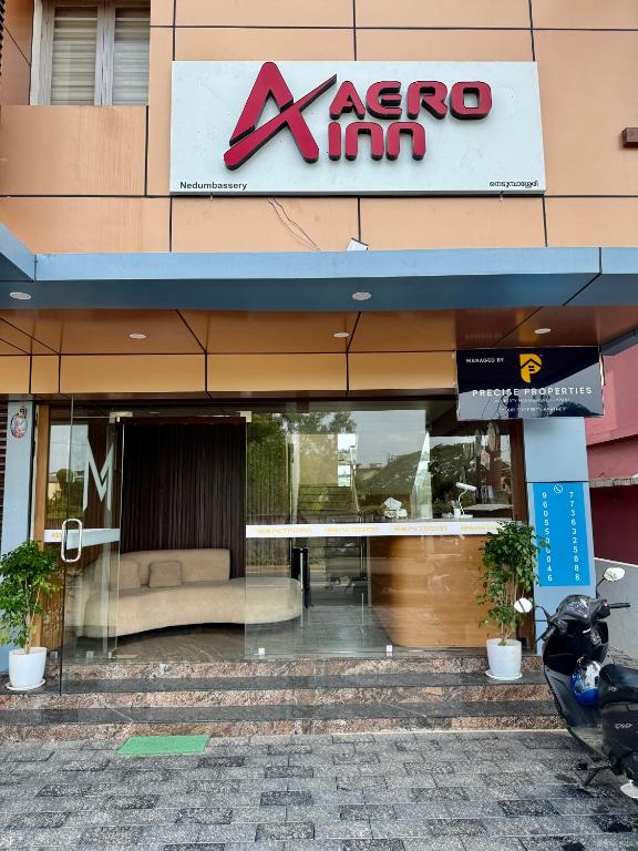 a store front of aaza inn with a sign on it at Aero Inn in Nedumbassery