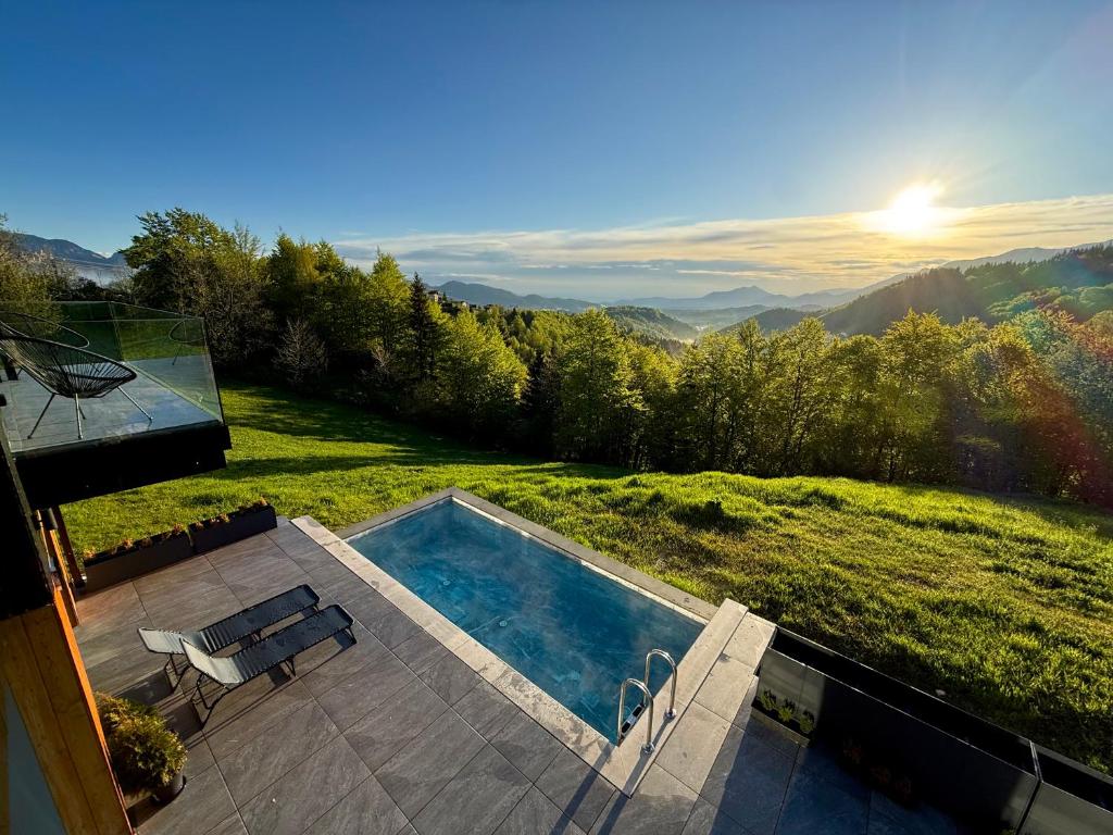 a swimming pool on top of a hill with a view at Nordic Star Chalet in Fundata