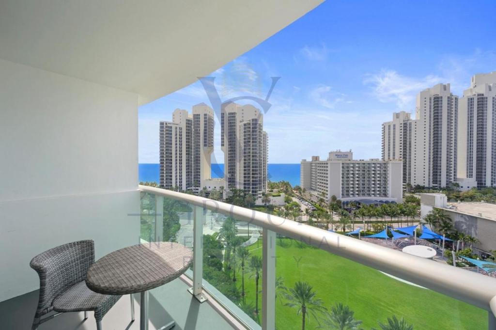 a balcony with two chairs and a view of the city at Ocean Reserve Miami Sunny Isles Collins Ave in Sunny Isles Beach