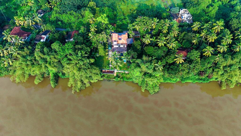 an aerial view of a house on an island in the water at Breezy River in Kalutara