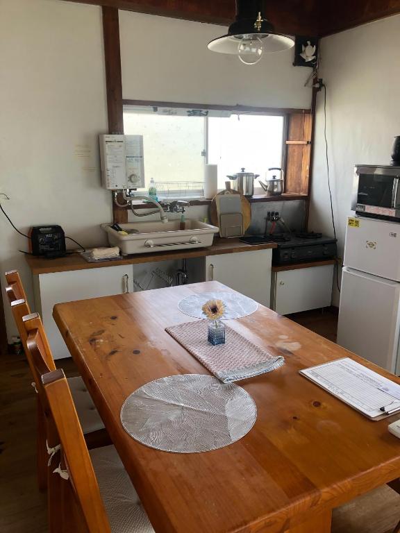 a kitchen with a wooden table with a vase on it at TORAMIKE2 - Vacation STAY 53883v in Ichigaya