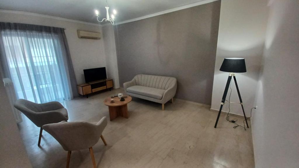 a living room with a couch and a chair at P&M House in Agrinio