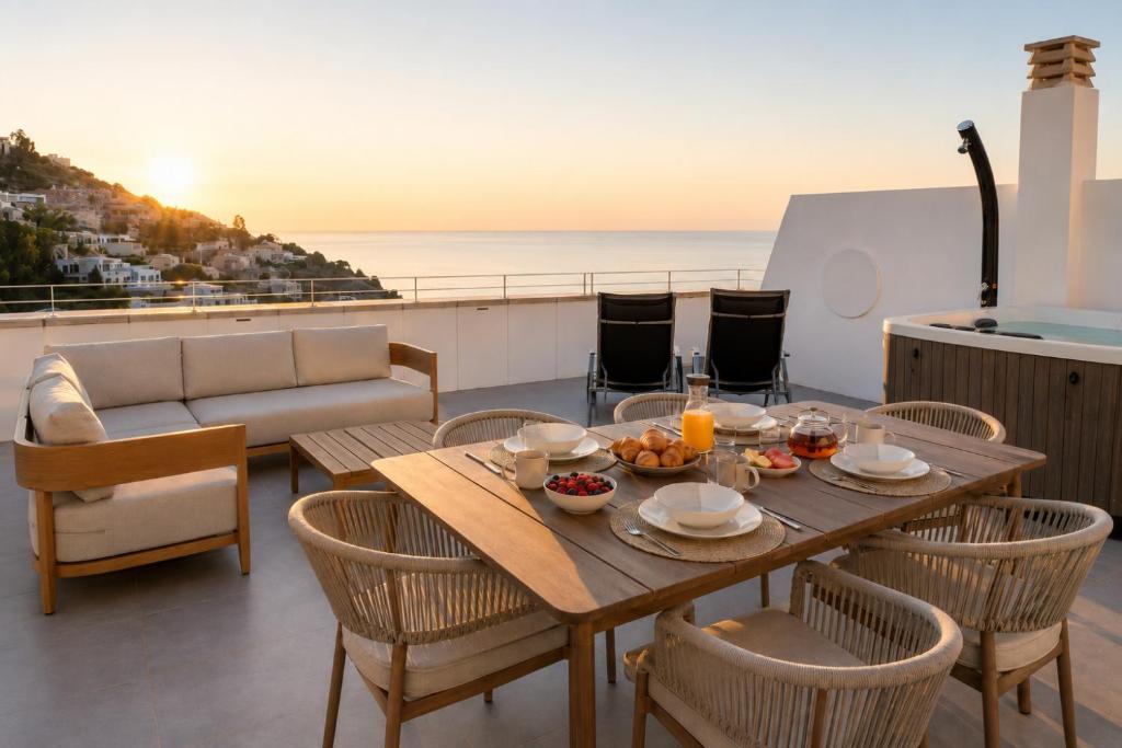 a table and chairs on a balcony with a view of the ocean at Altea Sol Marina Apartment by NRAS in Altea