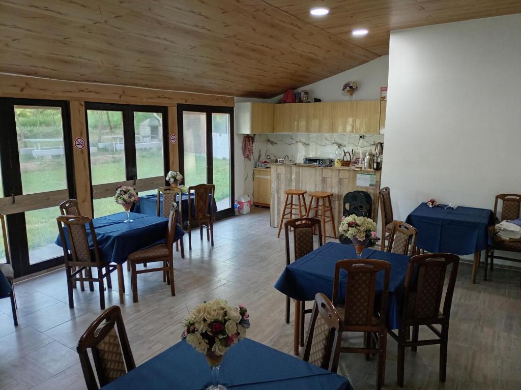 a dining room with blue tables and chairs at Etno Han crvena reka in Bela Palanka