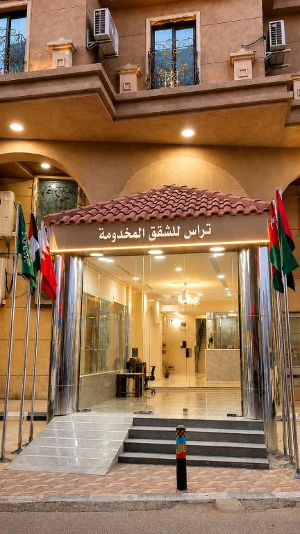 a building with a entrance with flags in front of it at تراس للشقق المخدومة in Dammam