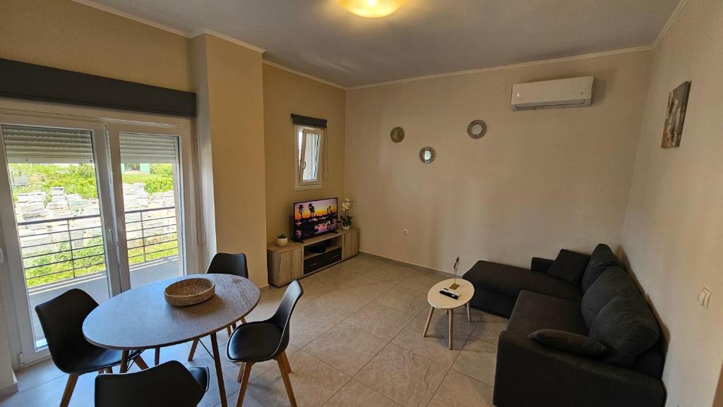 a living room with a couch and a table at Estia Chios Apartments B3 in Karfas