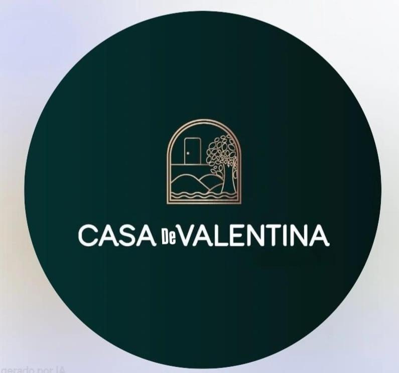 a green circle with the logo of a villa be valentina at Casa De Valentina in Tiradentes