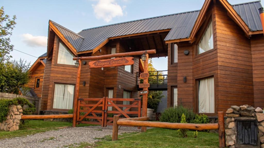 a log cabin with a sign in front of it at Patagonia Encantada in Esquel